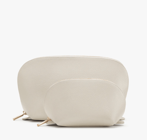 small and large white leather travel cases with gold zipper